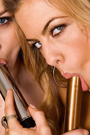 Shaved lesbians Mia Presley and Karlie Montana love playing with metal dildos