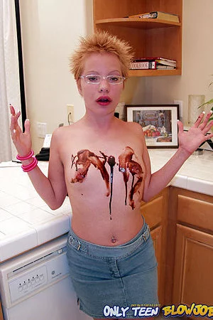 Short haired glassed chick Emily Da Vinci shows off her small chocolate covered tits