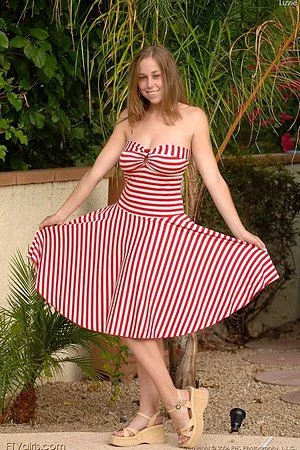 Wearing a red candy cane print dress Carly Kaleb gives the hot pussy shots and lets her tits swing.