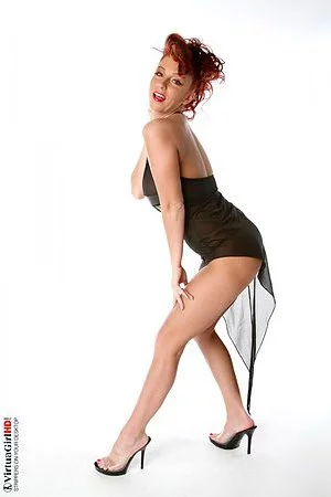 The horny redhead girl Ashley Robbins is playing her nice big melons on the camera