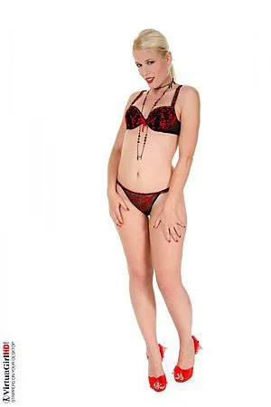 Pretty lingerie blonde Sandra Sweet is erotically playing with her nude body