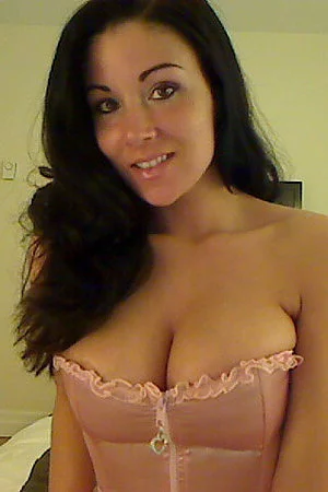 Attractive big tit brunette Sweet Krissy shows off her perfect ass with her pink thong on