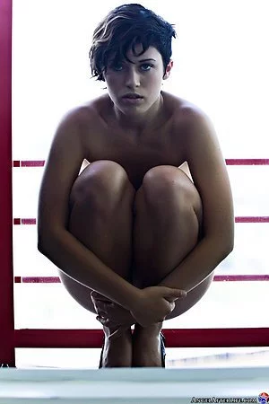 Sexy brunette teen Lexus Afterlife demonstrating tattoo on the naked body