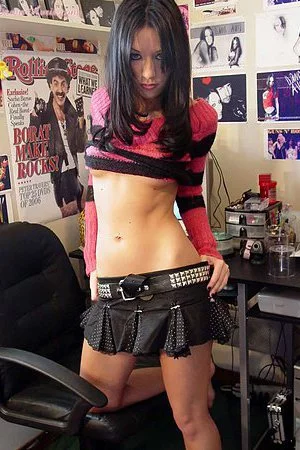 Sexy brunette babe Dawn Avril sexily strips showing her small tits and slim body