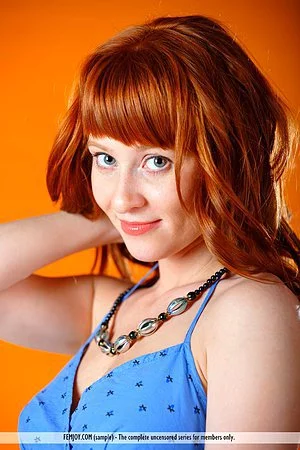 Gorgeous young redhead Polina Nubiles slips out of her lingerie to make juicy softcore porn 