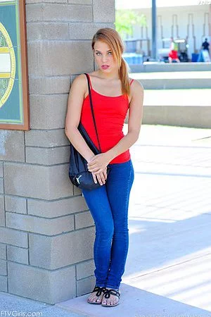 Lovely redhead teen chick Daisy Dalton shows off every inch of her teen bod outside