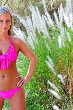 Perverted blonde Melissa Matters takes off the bikini and uses garden instruments for masturbation