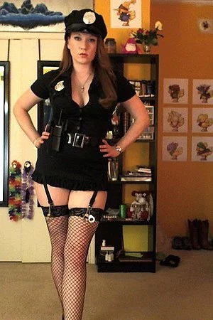 Filthy redhead Lucy OHara is a police officer in sexy uniform and fishnet stockings