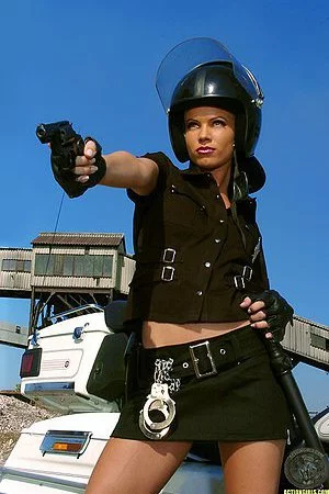 Sexy police babe Marketa B with ultra long legs shows her boobs in the sun.