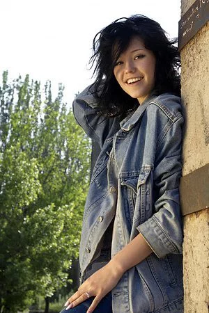 Naughty brunette doll Eleonora B strips and has fun outdoors pouring water on her nude body