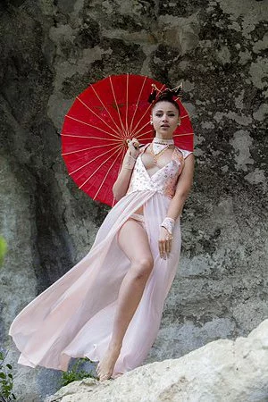 Lovely redhead babe Red Fox poses outdoors and gets rid of her vintage outfit