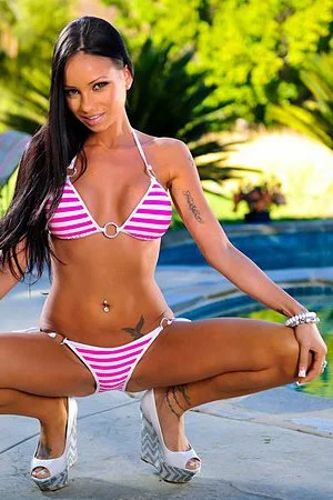 Latina chick Raven Bay is losing off her striped bikini boasting with big booty and tits