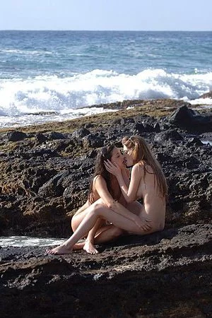 Lesbian girls Faye Reagan and Georgia Jones remove their bikinis and pose with guys on the beach.
