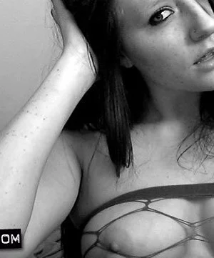 Erotic fishnet dress is covering the naked body of young looking chick Freckles