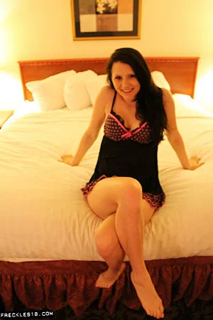 Delectable brunette teen babe Freckles removes her lingerie in bed and fingers her cunt