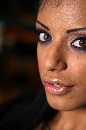 Dark eyed porn actress Kyra Black dressed in black gives backstage interview