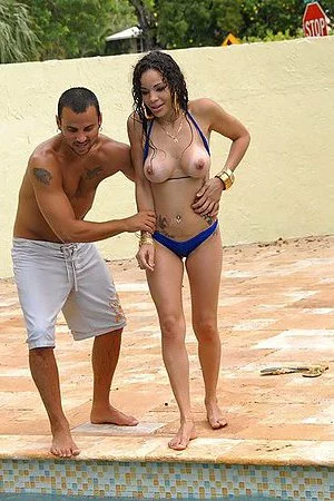 Bikini clad latinas China Doll and Carmen Love enjoy big cocks in the pool