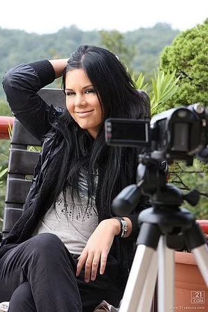 Behind-the-scene shooting with brunette babe Madison Parker posing in a black suit