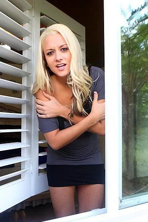 The charming blonde Brandy Blair is getting spied half naked through the curtains