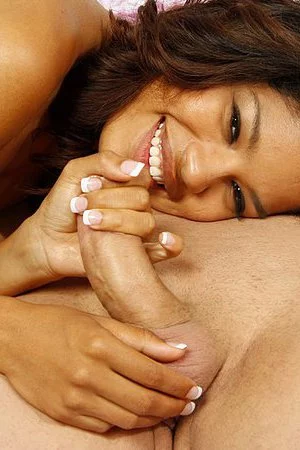 Bronze skinned latina teen Carmella Woods gives nice handjob naked with smile on her face