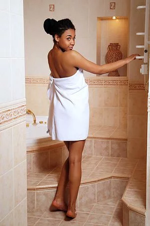 Charming black bimbo Gana A is not going to hide her shaved pussy under the towel