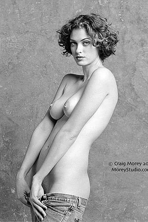 Young beauty Helena Morey is pulling up her sweatshirt and exciting by showing her appetizing boobs and cunt