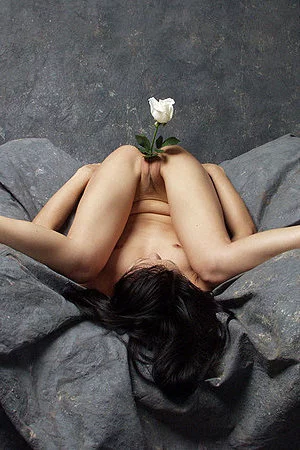 Naughty chick with hotly shaped body Tiger Lily is pulling up her legs to head and stuffing flower in her puss