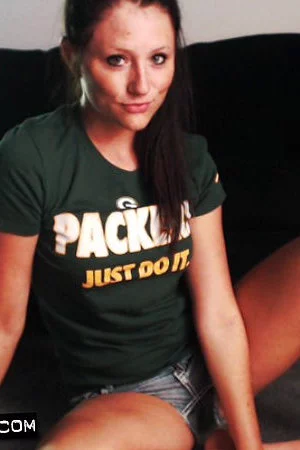 Stunning softcore honey Freckles takes her shorts off to pose butt naked on her couch.