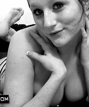 Saucy brunette Freckles teases in black lingerie and pleases her pussy with a stroking session.