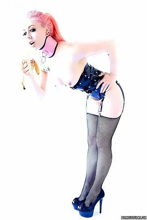 Topless girl in stockings Annabelle Lee is erotically eating banana before camera