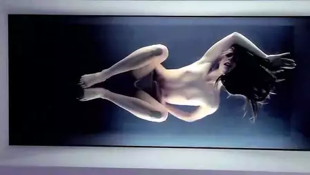 Cute Ebbi Nubiles is posing in the water tank and showing off her perfect body.