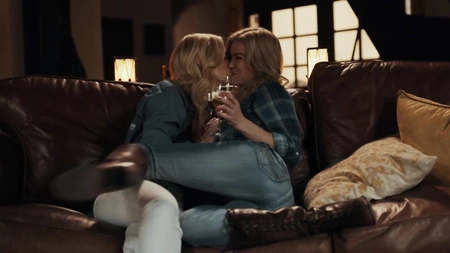 Charlotte Stokely and Serene Siren pleasuring each other on the sofa